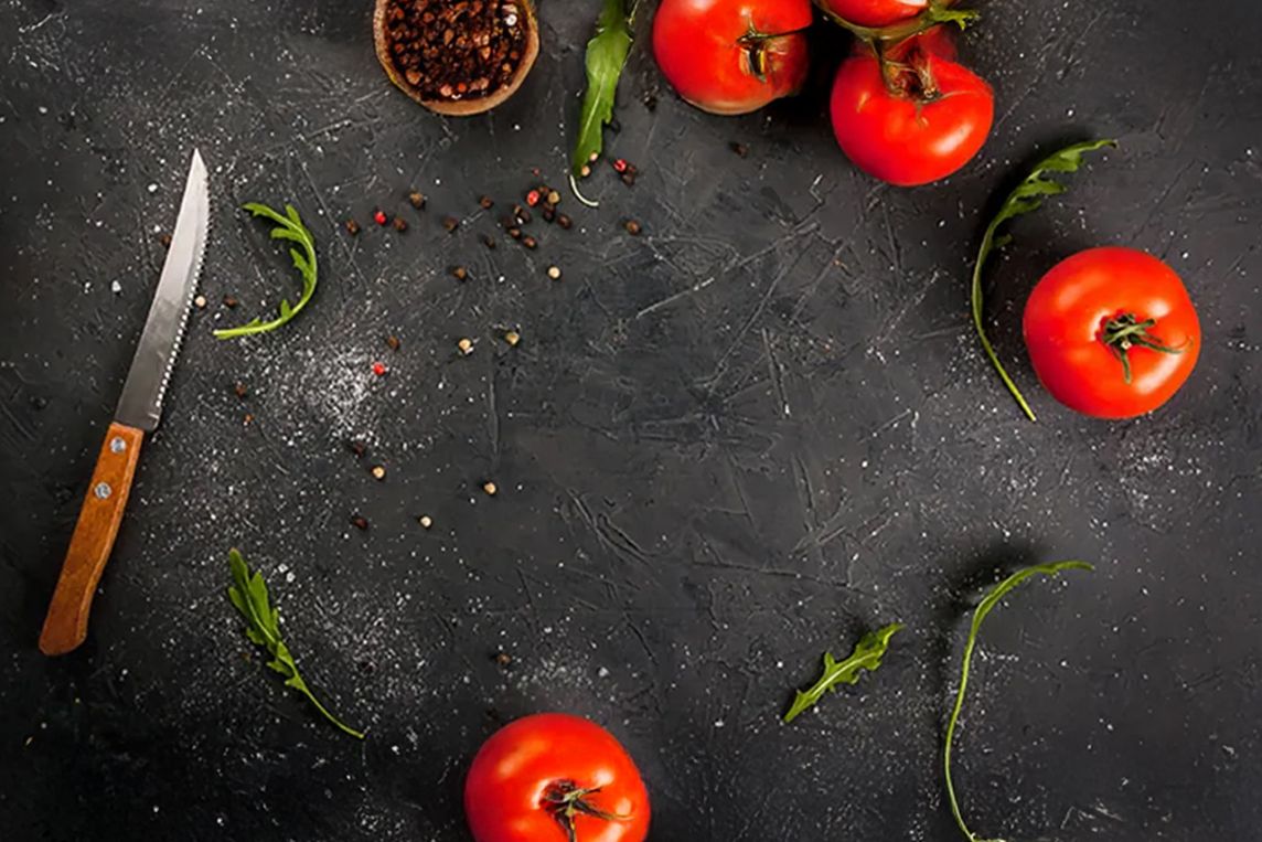 Cutting board with tomatoes and seasonings